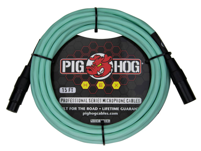 The image shows a 15-foot Pig Hog Professional Series XLR microphone cable with seafoam green/turquoise jacket and black metal connectors. It features male to female connectors, the red pig logo, yellow "HEX" badges, and "Built for the Road • Lifetime Guarantee" branding. Designed for professional audio use, this durable cable is ideal for microphones and audio equipment in live and studio settings.