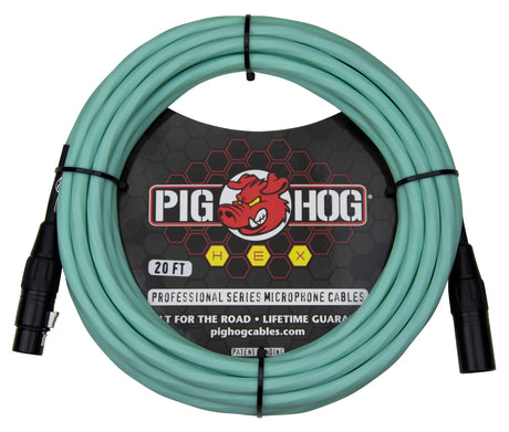 The image shows a 20-foot seafoam green Pig Hog Professional Series XLR microphone cable, coiled and secured with black ties. It features black XLR connectors, the brand’s red pig logo on black packaging, and "HEX," "Built for the Road," and "Lifetime Guarantee" labels. This durable, professional-grade cable is designed for live and studio use, easily identifiable by its distinctive color.