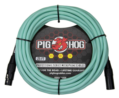The image shows a 25-foot seafoam green Pig Hog HEX professional XLR microphone cable with black male and female connectors. It features the red pig mascot logo and packaging stating "built for the road" with a lifetime guarantee. Designed for connecting microphones to audio equipment, this durable, colorful cable is popular among musicians and sound engineers for easy cable management.