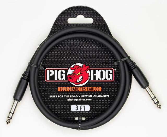 The image shows a Pig Hog Tour Grade 3-foot TRS audio cable with black metal 1/4" connectors and a black cable. It features the Pig Hog red pig logo, is built for durability with a lifetime guarantee, and is designed for professional use in balanced audio connections, instruments, mixing boards, and studio or live sound applications.