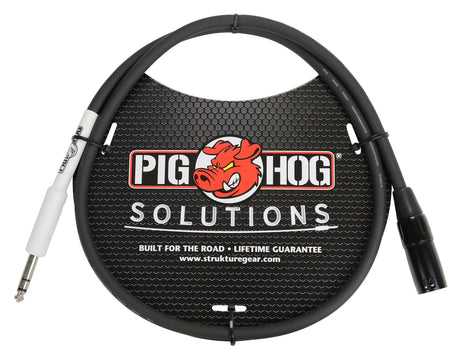 The image shows a Pig Hog Solutions black 1/4" TS instrument cable with one straight and one right-angle plug in white and black housings. The coiled cable is displayed with Pig Hog branding featuring a red pig logo. Marketed as "Built for the Road" with a lifetime guarantee, it’s designed for professional musicians to connect guitars, basses, pedals, and audio gear, offering durability and strain relief.