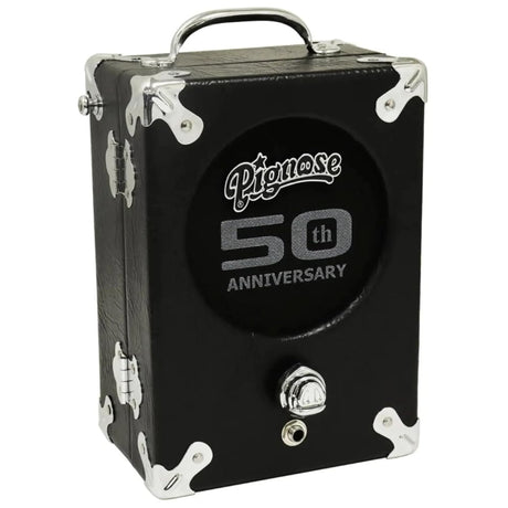 The image shows a black Pignose 50th Anniversary portable guitar amplifier with chrome corner protectors and hardware. It features the Pignose logo, "50th Anniversary" text, a carry handle, input jack, and control knob on a compact, suitcase-style rectangular design. This classic battery-powered amp, popular since the 1970s, is known for its vintage road case look and portability.