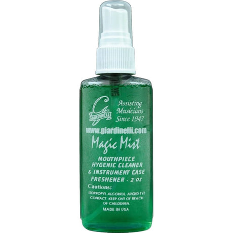 The image shows a 2 oz spray bottle of "Magic Mist" by Giardinelli, a mouthpiece cleaner and instrument case freshener for wind instruments. It contains green liquid with a white spray pump. Designed for hygiene, it includes isopropyl alcohol and safety warnings to avoid eye contact and keep away from children. Giardinelli has been assisting musicians since 1947.