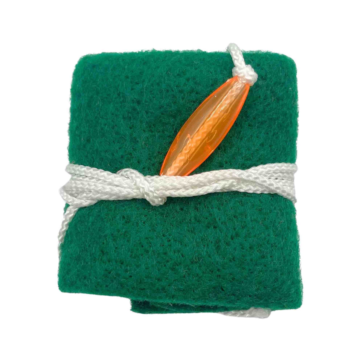 The image shows a green felt reed guard tied with white cord, holding an orange/amber woodwind reed, likely for clarinet, saxophone, or oboe. This protective case cushions and absorbs moisture to keep the delicate reed safe during transport and storage. Reed guards are essential for woodwind players to maintain reed condition and ensure sound quality.