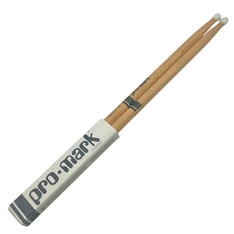 The image shows a pair of Pro-Mark wooden drumsticks with white nylon tips in their original packaging. They have a natural wood finish with Pro-Mark branding and a model number on the shaft. The white tips are favored for producing a brighter cymbal sound and greater durability compared to wooden tips.