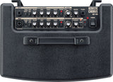 The image shows an Acoustic Chorus AC-60 guitar amplifier designed for acoustic instruments. It features two input channels: guitar and mic/line, both with volume, bass, middle, treble, and chorus controls. Additional features include built-in chorus, reverb/delay, anti-feedback, master volume, headphone output, and phantom power. It has a compact, dark gray/black textured design with multiple knobs and input jacks.