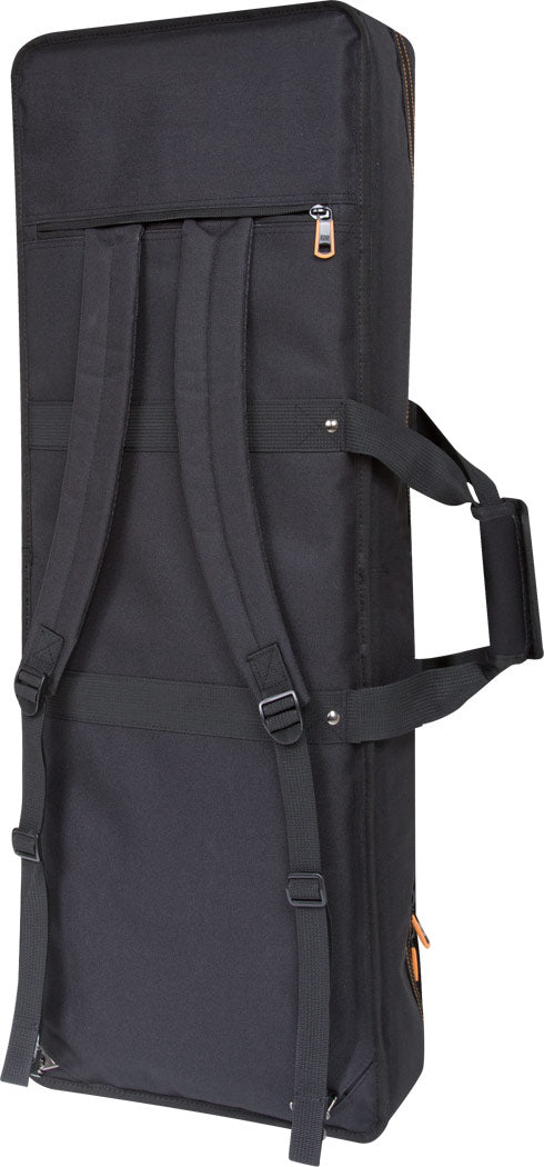 The image shows a black, rectangular gig bag made of durable fabric, designed for electric guitars or similar instruments. It features padded backpack straps, a zippered front pocket for accessories, heavy-duty zippers with orange/brown pulls, reinforced handles, and a sturdy, professional design. This soft case offers portable, protective transport for musicians’ instruments.