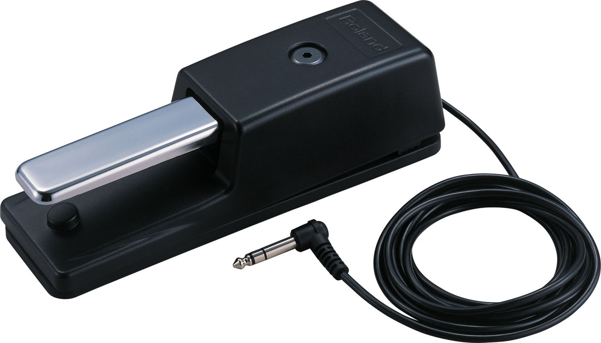 The image shows a Roland sustain pedal for electronic keyboards and digital pianos. It has a black plastic base, a silver metal foot pedal, and an attached cable with a 1/4" connector. This pedal replicates the acoustic piano’s sustain function, allowing notes to ring after keys are released, enhancing musical expression and performance.