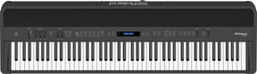 The image shows a Roland digital piano with 88 full-size weighted keys, simulating an acoustic piano feel. It features a sleek black finish, a control panel with buttons, sliders, and a small LCD display for sound selection and adjustments. Roland branding is visible in the top right corner. This versatile instrument is popular with pianists and producers for its authentic touch and digital functionality.