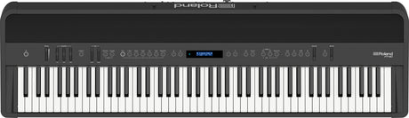 The image shows a Roland digital piano with 88 full-size weighted keys, simulating an acoustic piano feel. It features a sleek black finish, a control panel with buttons, sliders, and a small LCD display for sound selection and adjustments. Roland branding is visible in the top right corner. This versatile instrument is popular with pianists and producers for its authentic touch and digital functionality.