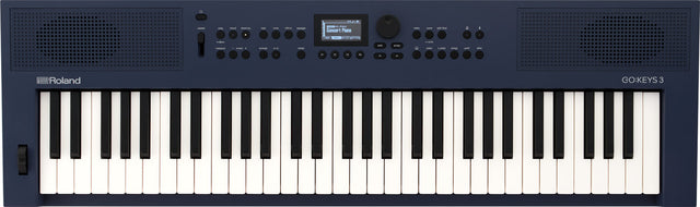 The image shows a Roland GO:KEYS 3 electronic keyboard with a 61-key piano-style layout in a dark blue body. It features built-in speakers on both sides, a small central LCD screen, multiple control knobs and buttons for sound and rhythm settings, and volume controls. The Roland logo is on the left, with the GO:KEYS 3 model name on the right. This portable keyboard is designed for beginners and casual players.