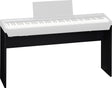 The image shows a white/light gray digital piano with 88 black and white keys, mounted on a black wooden stand. It features a music stand at the back in an upright position. This modern stage or home digital piano combines the feel of an acoustic piano with digital convenience, popular for practice, performance, and recording.