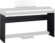The image shows a black wooden or composite keyboard stand designed to support a digital piano or electronic keyboard. It features a solid rectangular frame with a dark finish, a horizontal support surface, and a lower shelf. The sleek, furniture-style design provides stable, permanent support, ideal for home studios or practice rooms, contrasting with portable folding stands.