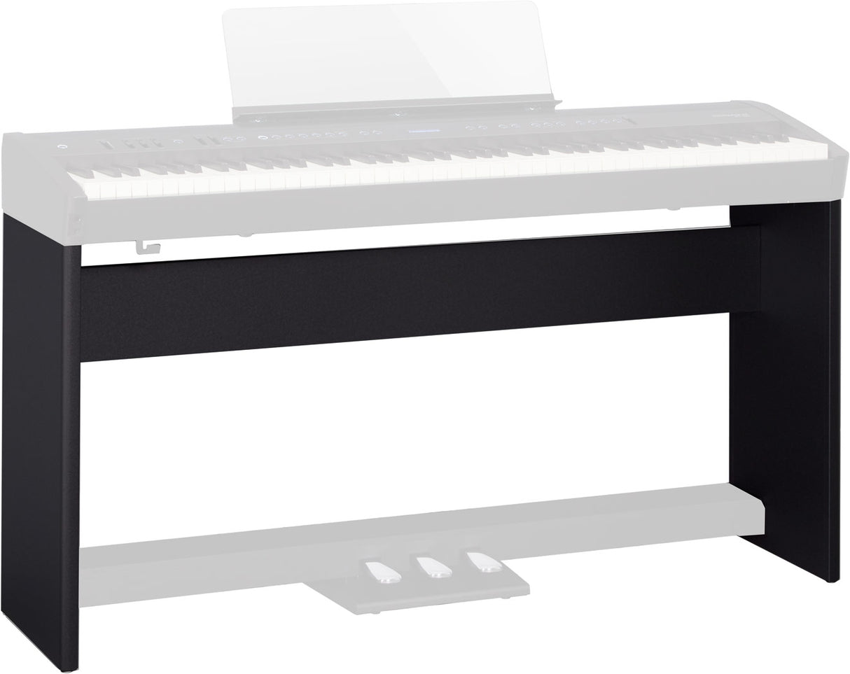 The image shows a black wooden or composite keyboard stand designed to support a digital piano or electronic keyboard. It features a solid rectangular frame with a dark finish, a horizontal support surface, and a lower shelf. The sleek, furniture-style design provides stable, permanent support, ideal for home studios or practice rooms, contrasting with portable folding stands.