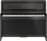 The image shows a Roland digital piano in a compact upright cabinet with a dark wood finish. It has a full 88-key weighted keyboard, a digital control panel with buttons and a small display, three pedals, and Roland branding on the music rack. This stylish, space-saving piano combines the feel of an acoustic piano with digital features like volume control and multiple voices, ideal for home use.