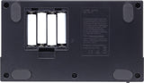 The image shows the bottom panel of a Roland MC-101 Groovebox. It features an open battery compartment holding 4 AA batteries on the left, and a label on the right with the model number, serial number, regulatory marks including CE, and "Made in Malaysia." The label also displays the Roland logo. Four rubber feet are visible in the corners to provide grip and stability.