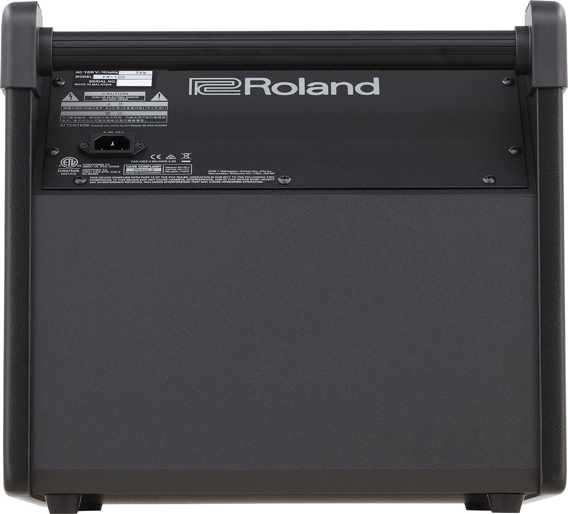 The image shows the back panel of a Roland musical instrument or amplifier with the "Roland" logo prominently displayed. It features a sturdy design with a carrying handle and corner protectors. A specification label with technical info, safety warnings, and regulatory markings, including a CE mark, is visible. The panel includes a power inlet (marked "A"). This likely belongs to a professional keyboard or guitar amplifier from Roland’s product line.