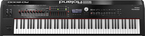 The image shows a Roland RD-2000 stage piano with a full 88-key weighted keyboard, a large display reading "Stage Grand," multiple red-rimmed rotary knobs, faders, buttons, LED indicators, and a data dial. It features a professional black finish and is designed for live performance and studio use, combining acoustic piano feel with advanced digital controls for professional musicians.