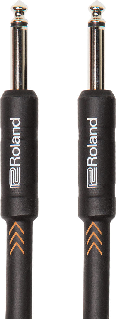 The image shows a Roland audio cable with two 1/4-inch (6.35mm) TS connectors, commonly used for guitars and other electric instruments. It features black connector housings with Roland branding, chrome metal plugs, and a black cable jacket with orange chevron markings. This durable, standard instrument cable is essential for connecting instruments to amps, pedals, or recording equipment.