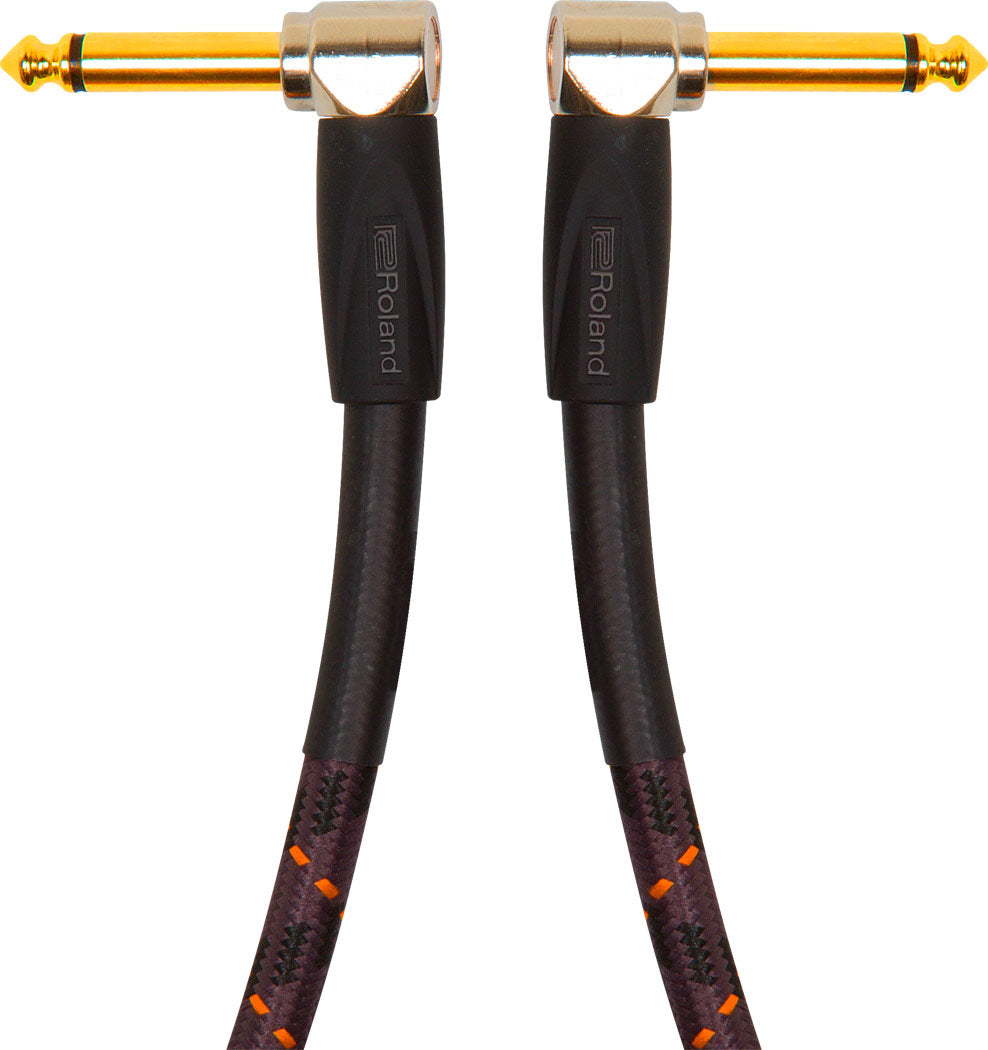 The image shows a high-quality instrument cable with gold-plated 1/4" (6.35mm) right-angle connectors on both ends. It features a black braided jacket with orange/red accents for durability and tangle resistance. The cable has Roland branding on the connector housings. Designed for guitars, basses, and keyboards, it offers reliable signal transmission and a low-profile, strain-reducing fit.