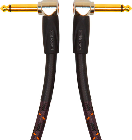 The image shows a high-quality instrument cable with gold-plated 1/4" (6.35mm) right-angle connectors on both ends. It features a black braided jacket with orange/red accents for durability and tangle resistance. The cable has Roland branding on the connector housings. Designed for guitars, basses, and keyboards, it offers reliable signal transmission and a low-profile, strain-reducing fit.