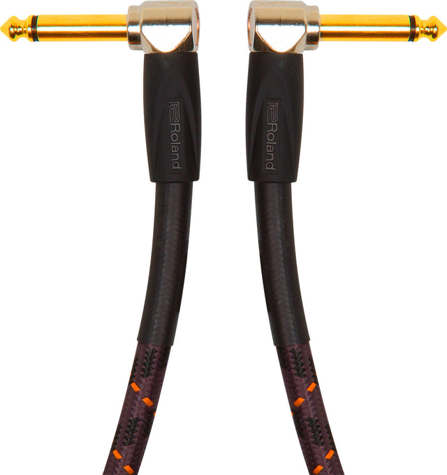 The image shows a high-quality instrument cable with gold-plated 1/4" (6.35mm) right-angle connectors on both ends. It features a black braided jacket with orange/red accents for durability and tangle resistance. The cable has Roland branding on the connector housings. Designed for guitars, basses, and keyboards, it offers reliable signal transmission and a low-profile, strain-reducing fit.