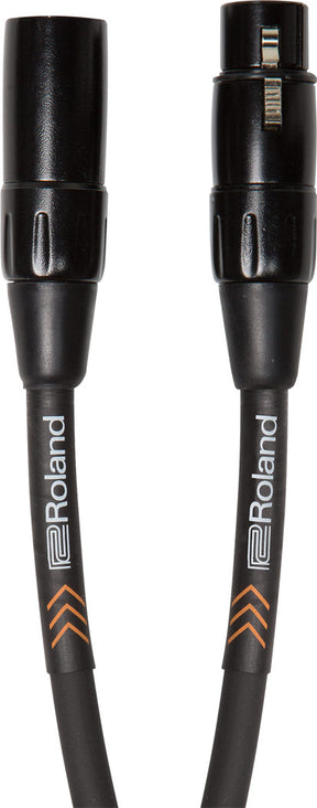 The image shows a Roland professional XLR audio cable with 3-pin connectors on both ends, black cable jacket featuring Roland branding, and orange chevron accent markings. The cable has sturdy black metal connector housings. It is used for connecting microphones, audio interfaces, mixers, and other professional audio equipment, providing reliable, noise-resistant balanced audio signals for studio, live sound, and recording applications.