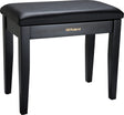 The image shows a Roland piano bench with a sleek black padded vinyl seat and four sturdy wooden legs. It features gold "Roland" branding on the front panel. Designed for comfort and proper posture, this bench is ideal for use with digital pianos, acoustic pianos, and keyboards. Known for stability and durability, it complements Roland’s electronic instruments or can be used with any piano setup.