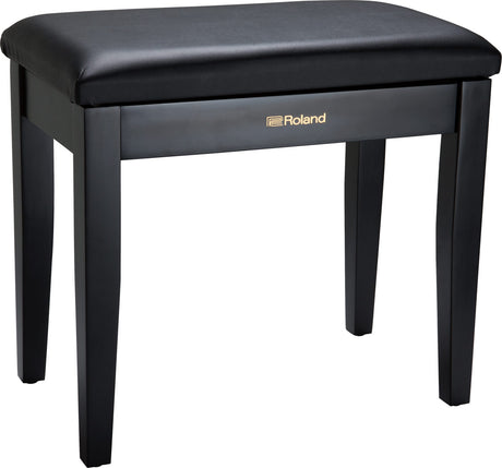 The image shows a Roland piano bench with a sleek black padded vinyl seat and four sturdy wooden legs. It features gold "Roland" branding on the front panel. Designed for comfort and proper posture, this bench is ideal for use with digital pianos, acoustic pianos, and keyboards. Known for stability and durability, it complements Roland’s electronic instruments or can be used with any piano setup.