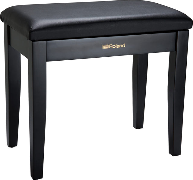 The image shows a Roland piano bench with a sleek black padded vinyl seat and four sturdy wooden legs. It features gold "Roland" branding on the front panel. Designed for comfort and proper posture, this bench is ideal for use with digital pianos, acoustic pianos, and keyboards. Known for stability and durability, it complements Roland’s electronic instruments or can be used with any piano setup.