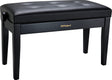 The image shows a Roland piano bench with a sleek black finish and a padded, button-tufted vinyl seat. It has four sturdy wooden legs and features the Roland logo in gold on the front panel. This professional-quality, adjustable bench is designed for comfortable seating during piano and keyboard practice or performance. Roland is a well-known brand in digital pianos and electronic instruments.