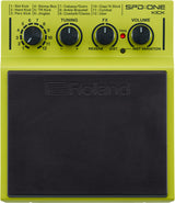 The image shows a Roland SPD::ONE KICK electronic drum pad in bright lime green. It features a selector dial with 12 kick, percussion, and effect sounds, three control knobs for tuning, effects, and volume, a red trigger button, and a toggle switch. The pad has a large black rubber surface with the Roland logo and a compact, portable design typical of the SPD::ONE series.