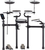 The image shows an electronic drum kit with multiple round drum pads in white and black, two larger cymbal pads at the top, a black electronic module with a display on the left, a black metal rack holding everything, and two foot pedals at the base. This compact kit allows quiet practice, recording, and a variety of sounds, ideal for home use, studios, and live settings.