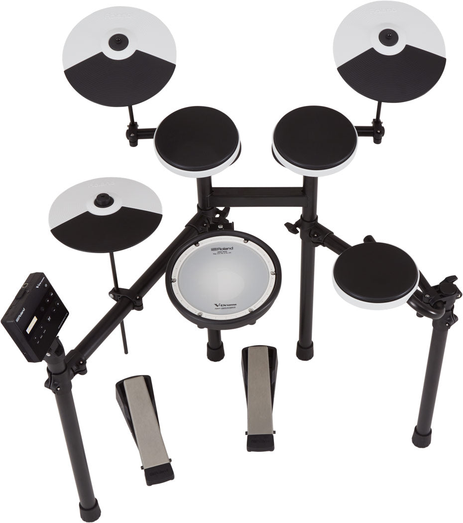 The image shows a Roland V-Drums electronic drum kit featuring multiple black and white drum pads, cymbal pads with sectioned designs, a central white mesh snare pad, and a sturdy black metal rack. It includes an electronic module for sounds and controls, adjustable mounting hardware, and a hi-hat pedal, replicating an acoustic drum set with electronic benefits.