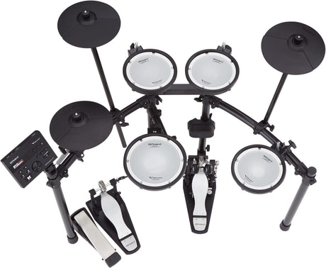The image shows a Roland electronic drum kit with multiple mesh drum pads, black electronic cymbal pads, a kick drum trigger, hi-hat pedal, and a drum module on an adjustable metal rack. The dual-zone pads and responsive cymbals offer realistic play, while the module provides diverse sounds and settings. This compact kit is ideal for practice, recording, and live use, delivering acoustic-like feel and versatility in a space-saving design.
