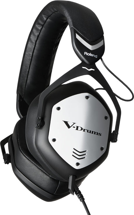 The image shows a pair of Roland V-Drums headphones, designed for electronic drumming. The white and black ear cups display the "V-Drums" branding, and the Roland logo is visible on the headband. These headphones are built for accurate sound reproduction and comfort during extended use, making them ideal for practicing quietly or monitoring electronic drum kits.