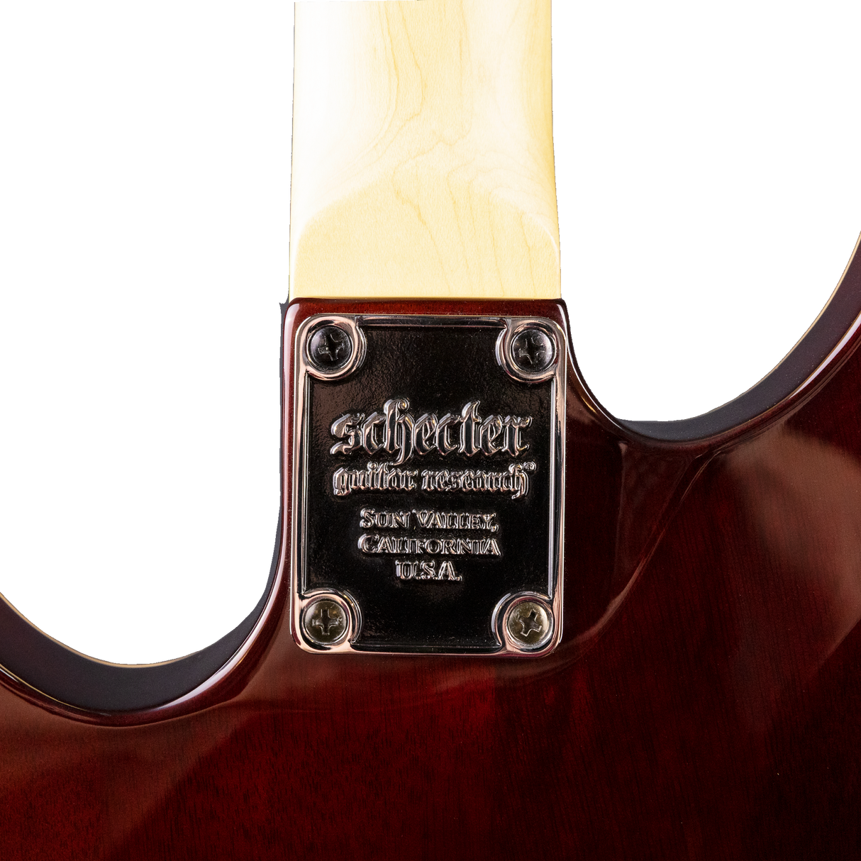 Close-up of the back of a Schecter guitar neck joint with brand name and location details.