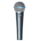 The image shows a Shure Beta 58A dynamic microphone, a professional vocal mic with a dark metallic body, silver mesh grille, and blue accent ring. Known for its durability and supercardioid pattern, it offers clear vocals and excellent feedback rejection. Widely used by musicians and sound engineers, it’s a standard choice for live performances and studio recording.