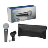 The image shows a Shure BETA 58A vocal microphone package, including a silver retail box with blue accents, the black dynamic microphone with a mesh grille, a black microphone clip, a metal thread adapter, and a black zippered carrying pouch embossed with "SHURE." The BETA 58A is known for durability, feedback rejection, and clear vocal quality, favored by vocalists for live and studio use.