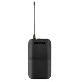 The image shows a Shure wireless bodypack transmitter with a compact black design, extendable antenna, and green LED indicator. This portable device is used by musicians and vocalists to wirelessly send audio signals from microphones or instruments to receivers in live sound and recording setups. Shure is a trusted brand in professional audio for reliable wireless systems.
