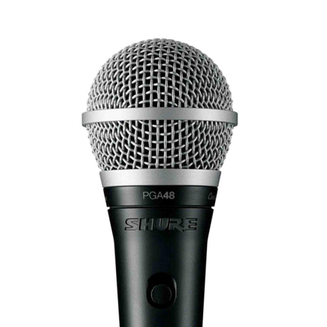 The image shows a Shure PGA48 dynamic handheld vocal microphone featuring a silver spherical wire mesh grille, black metal body with the "SHURE" logo, the model number "PGA48" near the handle, and an on/off switch. This entry-level microphone is designed for live vocals, known for durability and good sound quality, making it suitable for performances, rehearsals, and basic recordings.