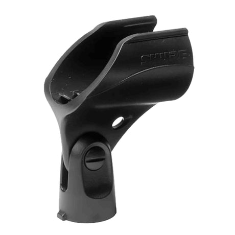 The image shows a black plastic microphone clip, also called a mic clip or holder, used to securely mount microphones on stands. It features a curved cradle for the microphone, an adjustable clamp, a threaded socket for stand attachment, and "SHURE" branding, indicating it’s likely made by Shure. This essential audio accessory is widely used by musicians and audio professionals for stable mic positioning in performances and recordings.