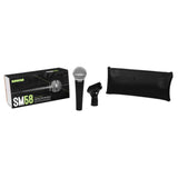 The image shows a Shure SM58 dynamic microphone package, including the iconic microphone with its ball grille and black handle, a black retail box with green Shure branding, a microphone clip for mounting, and a black zippered carrying pouch. The SM58 is renowned for its durability and vocal clarity, widely used in live and studio settings.