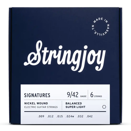 The image shows a package of Stringjoy Signatures series electric guitar strings. It’s a 6-string set with super light 9-42 gauge nickel wound strings featuring balanced tension design. The navy blue packaging has white text and a "Made in Nashville, TN" logo, indicating American-made quality. This set offers consistent tension across strings, favored by lead guitarists for easier bends.