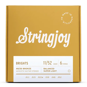 The image shows a package of Stringjoy "Brights" acoustic guitar strings in an attractive mustard yellow box. The set features 80/20 Bronze, super light gauge 11/52 strings (.011–.052) in a balanced 6-string configuration. The packaging highlights the brand name, product details, and a "Made in Nashville" badge, reflecting a premium, boutique quality product.