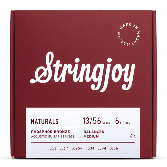 The image shows a package of Stringjoy acoustic guitar strings, medium gauge (.013–.056) phosphor bronze, balanced medium tension. The deep red box features clean white script logo, "Made in Nashville, TN" in the top right, and a minimalist design. The set includes six strings, known for warm tone and durability, from Stringjoy’s "Naturals" line.