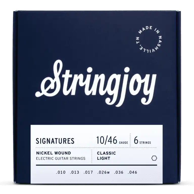 The image shows a dark blue box of Stringjoy "SIGNATURES" electric guitar strings with white script lettering. It features 6 nickel-wound strings, Classic Light gauge 10-46 (.010, .013, .017, .026w, .036, .046), made in Nashville, TN. The packaging is sleek and professional, indicating a premium set that balances playability and tone for electric guitars.