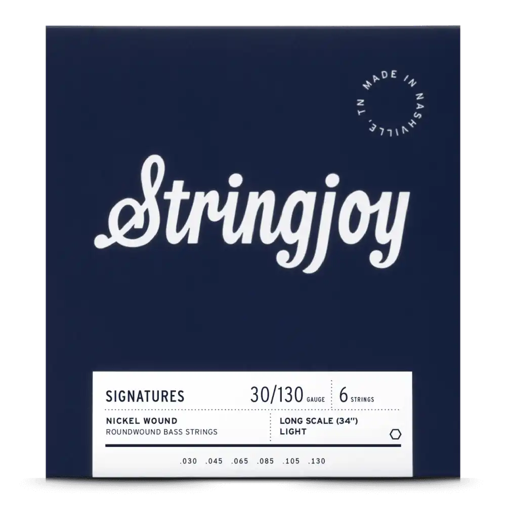The image shows a package of Stringjoy "Signatures" 6-string bass guitar strings, gauge 30-130, nickel roundwound, long scale (34"), light tension. The packaging is dark navy blue with white text and includes a "Made in Nashville, TN" logo. This American-made set is designed for extended range and high-quality performance on 6-string bass guitars.