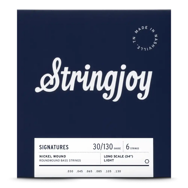 The image shows a package of Stringjoy "Signatures" 6-string bass guitar strings, gauge 30-130, nickel roundwound, long scale (34"), light tension. The packaging is dark navy blue with white text and includes a "Made in Nashville, TN" logo. This American-made set is designed for extended range and high-quality performance on 6-string bass guitars.