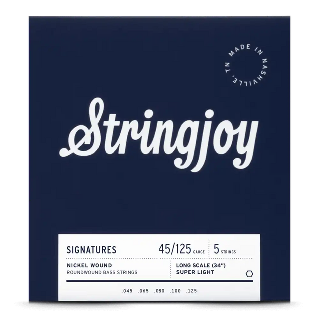 The image shows a package of Stringjoy 5-string bass guitar strings with a 45-125 super light gauge, designed for long scale (34") basses. The deep navy packaging features white cursive branding, a "Made in Nashville, TN" badge, and a white label listing nickel roundwound string specs (.045, .065, .080, .100, .125). This professional set is favored for playability and tone.